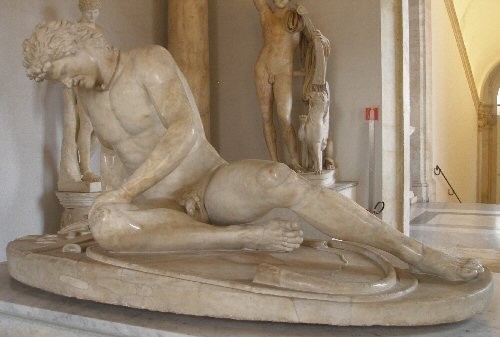 Marble sculpture of a dying Gaul. He is already down on the ground, a torque around his neck.