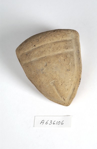 Clay votive offering of a vulva depicting a hairless pubic triangle with a clear slit.