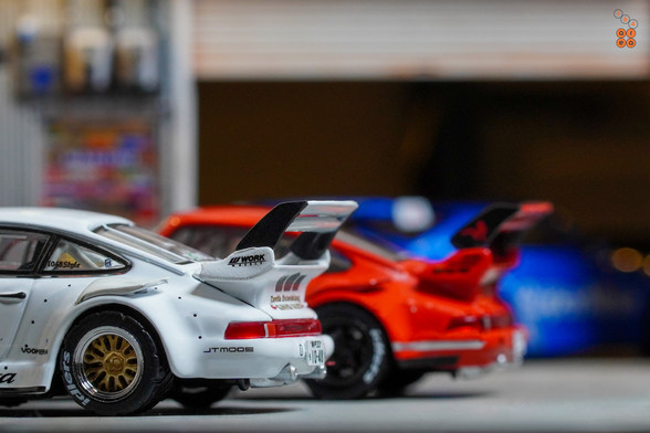 A back side view of Porsche RWB 930 Kamizawa and Painkiller Ver 2 by Tarmac Works in 1:64 scale with 1:64 figure on area 164