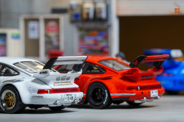 A back side view of Porsche RWB 930 Kamizawa and Painkiller Ver 2 by Tarmac Works in 1:64 scale with 1:64 figure on area 164