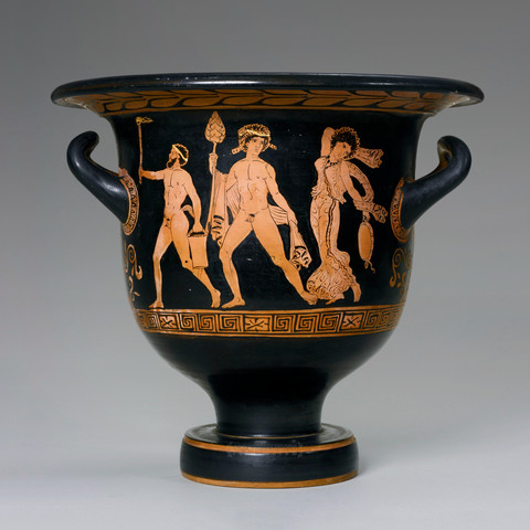 Dionysos, Silenos, and a Maenad on a red-figure bell krater dated to the early 4th century BCE. Silenos is leading with a torch, Dionysos looks back at his maenad, thyrsos in hand. The maenad looks like she's dancing, her body in a dynamic pose with one arm raised behind her head and she is holding a tambourine in the other.
