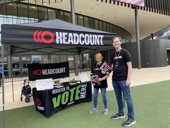 Dan + Shay show at Moody Center. 2 volunteers in front of the HeadCount table under the new HeadCount tent the org sent me. Spiffy, huh?