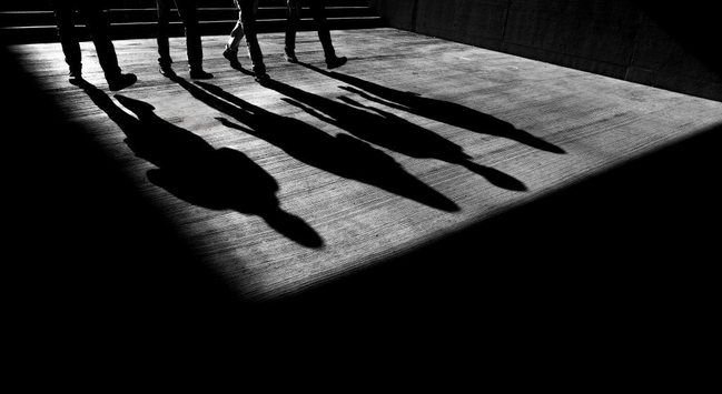Shadows of four people walking
