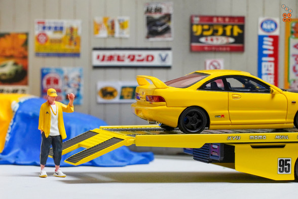 A yellow Honda Integra Type-R DC2 by Nice Auto in 1:64 scale with 1:64 figure on AREA 164