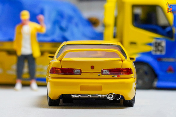 A yellow Honda Integra Type-R DC2 by Nice Auto in 1:64 scale with 1:64 figure on AREA 164