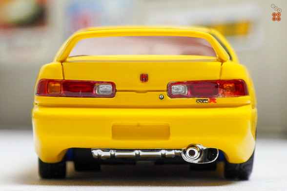 A close-up shot of yellow Honda Integra Type-R DC2 by Nice Auto in 1:64 scale with 1:64 figure on AREA 164