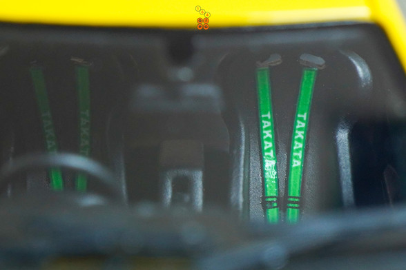 A close-up shot of yellow Honda Integra Type-R DC2 by Nice Auto in 1:64 scale with 1:64 figure on AREA 164