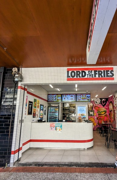 Fast food chain Lord of the fries
White tiles
Red and Black logo
Menu screens
Loud colourful adverts for vegetarian junk food