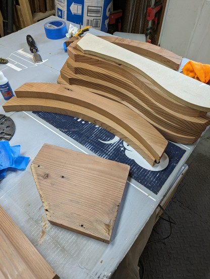 Stack of cedar boards cut with smooth sweeping cuvers
