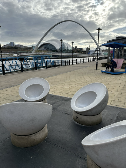 Grey oval seats on the Newcastle Quayside that look much like men’s urinals