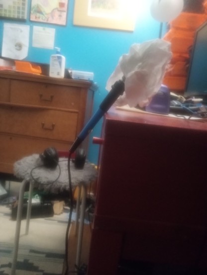 A soldering iron somehow balancing on a corner of my desk