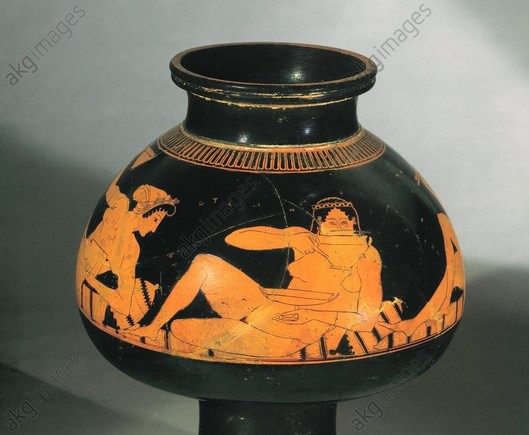 Red-figure vase painting of a woman who reclines naked on a bed of cushions, drinking from a wine cup. To her left and right other women are having fun as well.