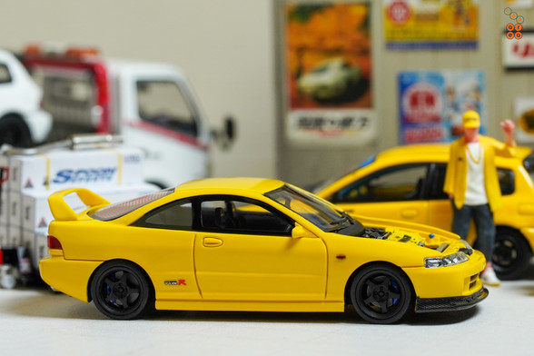 A yellow Honda Integra Type-R DC2 by Nice Auto in 1:64 scale with 1:64 figure on AREA 164