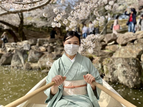 Boating beneath blossoms.