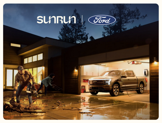 “Ford Intelligent Backup Power” marketing photo showing suburban couple cleaning up branches after a storm using house power from their Ford F150 
