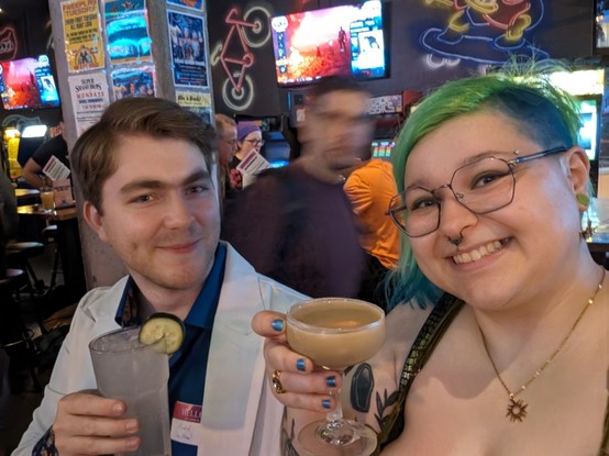 Me and Winston at a bar, dressed up and holding drinks