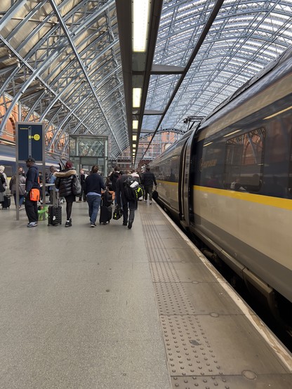 Looking down a train platform at London Saint Pancras Station. 
