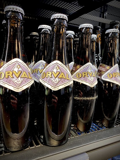 Bottles of Orval beer sitting on a shelf.