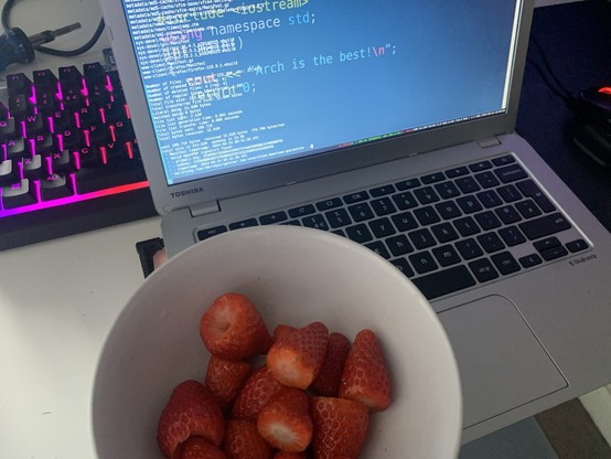 Strawberries next to my Gentoo Chromebook. The strawberries look yummy.