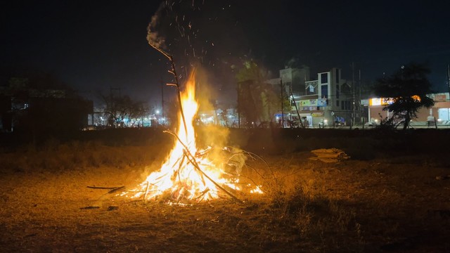 Bonfire burning in a field at night on the occasion of Holika Dahan