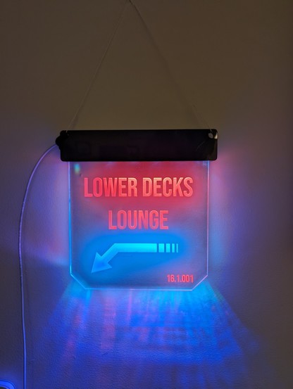 A glowing sign that says Lower Decks Lounge