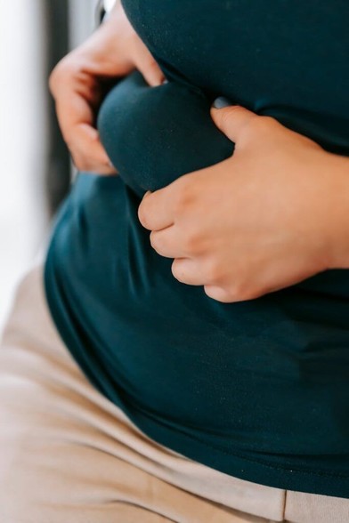 a woman holding fold on waist
