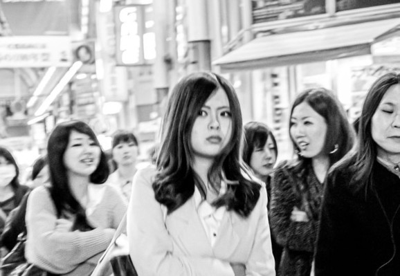 Black and white photograph of a group of women on the street in Osaka, Japan.