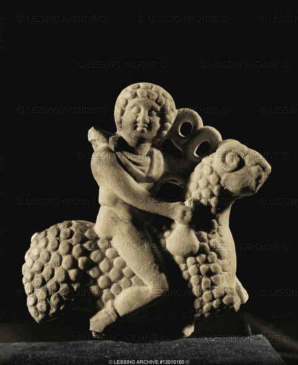 Marble statue of Hermes riding a curly-fleeced ram. His hair looks just like the ram's fur and he is holding his kerykeion staff, identifying him as Hermes.