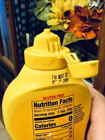 The top portion of a French’s® brand yellow mustard bottle. Matching the social posts that have been going around, the cap has been opened to its secondary, much wider, position.