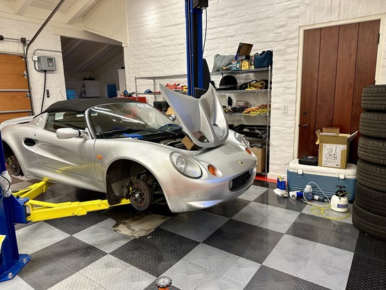 Silver 2001 Lotus Elise Series 1 on a lift after brake fluid replacement.