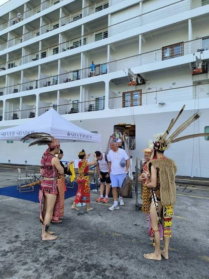 Passengers of the Silver Shadow Cruise receive a warm welcome after the ship docks at Senari Port. / Photo from linked article.