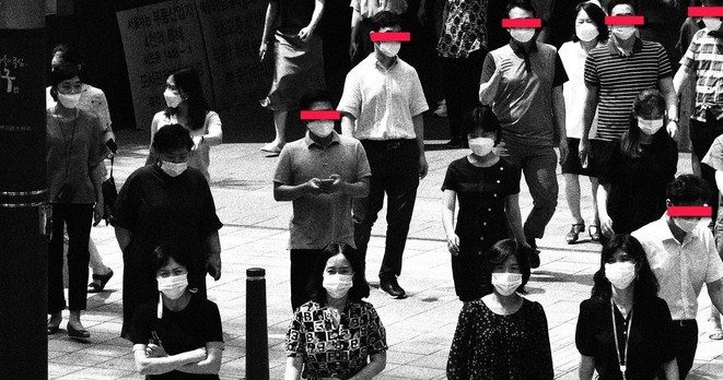 People with masks walking in Korea. Red bars across the eyes of men.