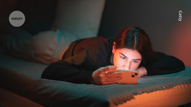 Teen looking at a screen while lying down