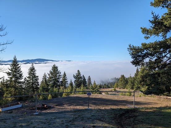view from the trail looking down on a fog covered lake