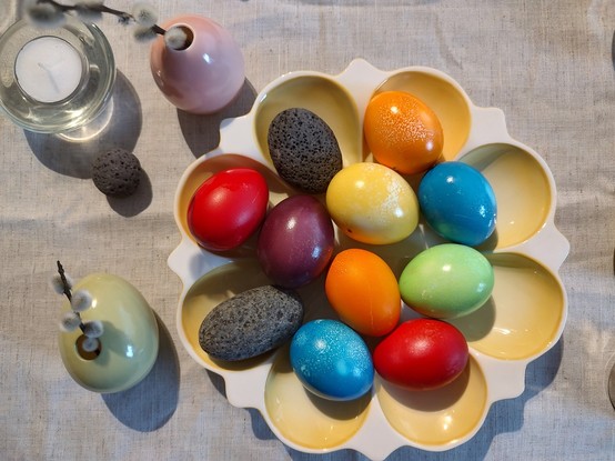 Easterdecor with egg shaped pebbles among the eggs