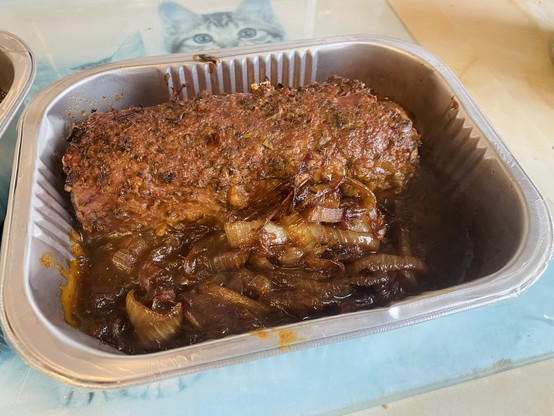 Cooked Aldi plant menu vegan no lamb roasting joint in tray with added caramelized onions