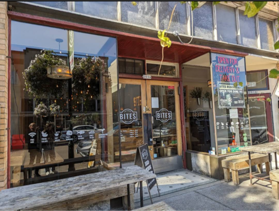 Streetview of a restaurant named "Bites" on a small town main street.