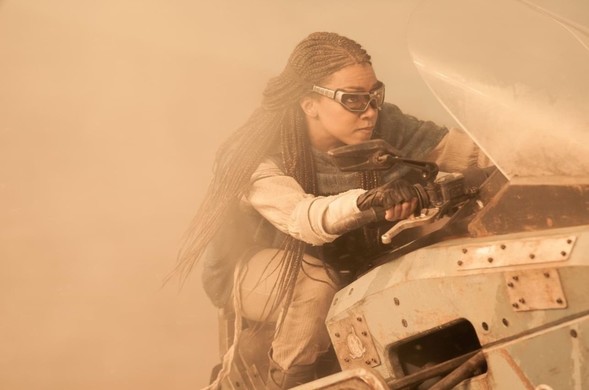 Capt. Burnham (Sonequa Martin-Green) is wearing goggles and riding some kind of hovercraft through a sandy, dusty environment.