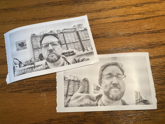 A photo of two thermal prints from a kid-style camera.