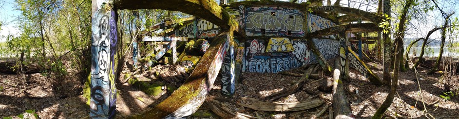 concrete trellis structure covered in graffiti tags 

this photo is a Google Cardboard camera photo. If you download it and view it in the Google Cardboard Camera app you will see some 3d depth and hear ambient sounds.