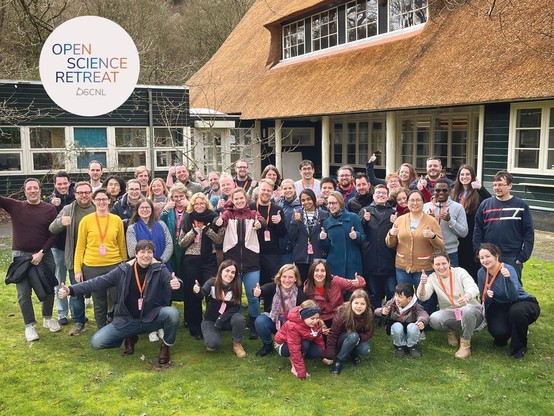 a group photo of most of the participants of the retreat, outside with thumbs up