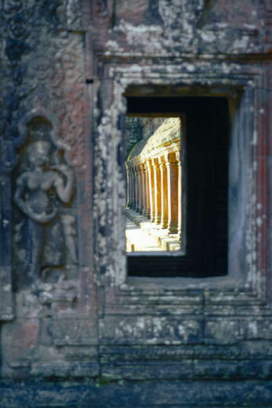 A window at Ta Prohm has a view of the pillars around the temple 