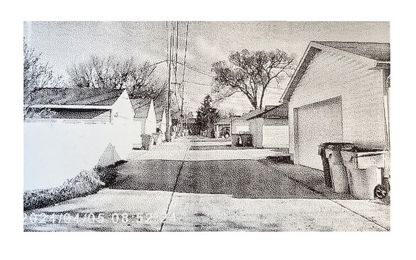 A thermal print from a toy camera showing an alley.