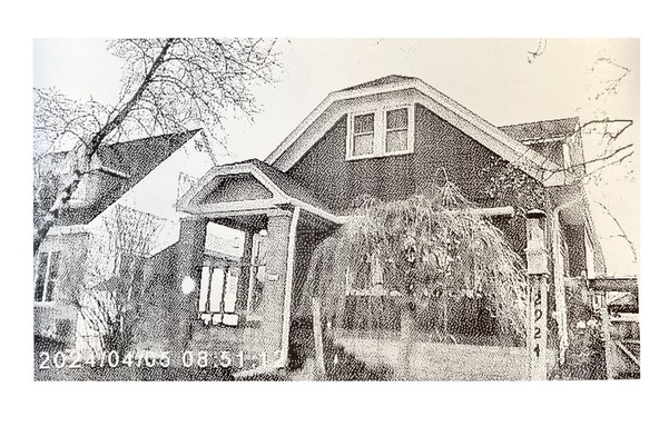 A thermal print from a toy camera showing a house.