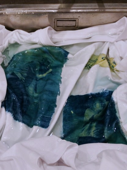 Rinsing the shirts to develop the print
