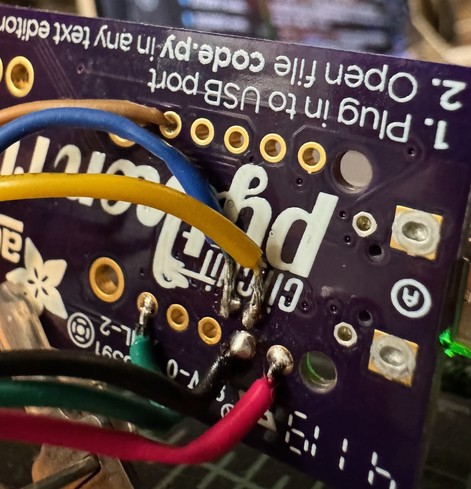 Terrible hack solder job to SWD interface pins on the back of the AdaFruit PyRuler