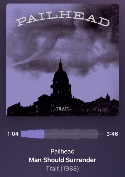 Music player interface showing the song "Man Should Surrender" by Pailhead from the album "Trait (1988),"