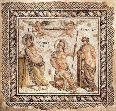 A large ancient Roman mosaic depicting the courtship of Ares and Aphrodite. Ares sits in the center wearing a crested helmet, he has been disarmed of his sword by two erotes that fly above. Aphrodite is to the left holding her scepter. To the right stands Euperpia, the personification of beauty.