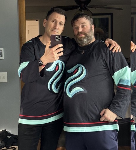 Two sexy boys in Seattle Kraken jerseys getting ready to see them lose.