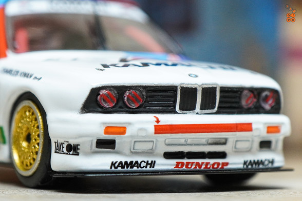 A close-up shot of BMW E30 M3, Kamachi racing livery by Tarmac Works in 1:64 scale  on AREA 164